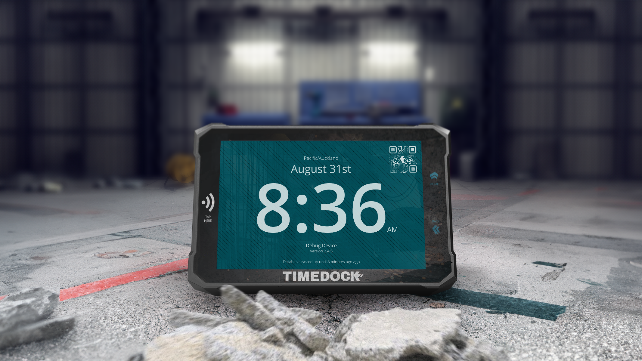 TimeDock machine sitting on the concrete floor of a workshop, looking like the handsomely rugged employee time clock that it is.